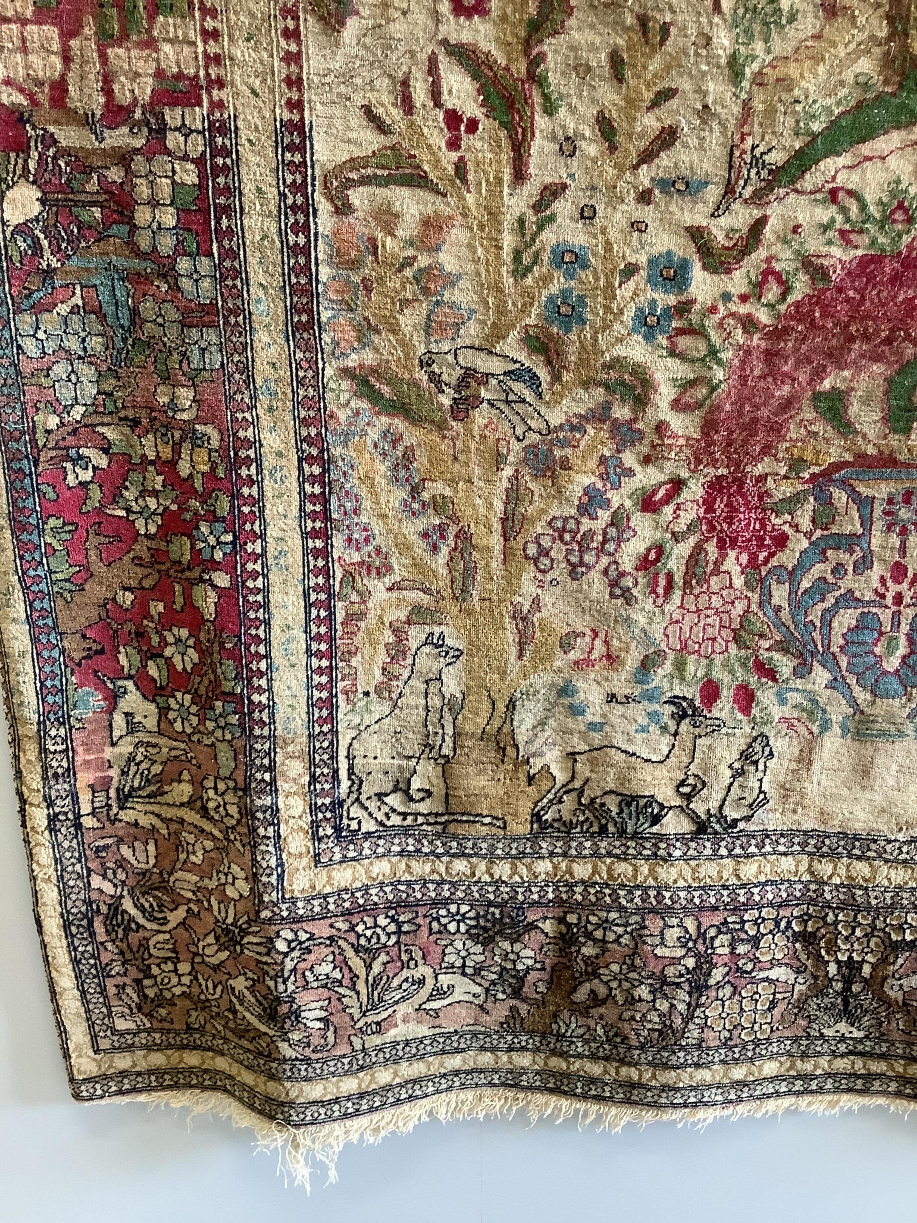 An antique Isphahan garden design ivory ground rug, approximately 200 x 130cm. Condition - fair